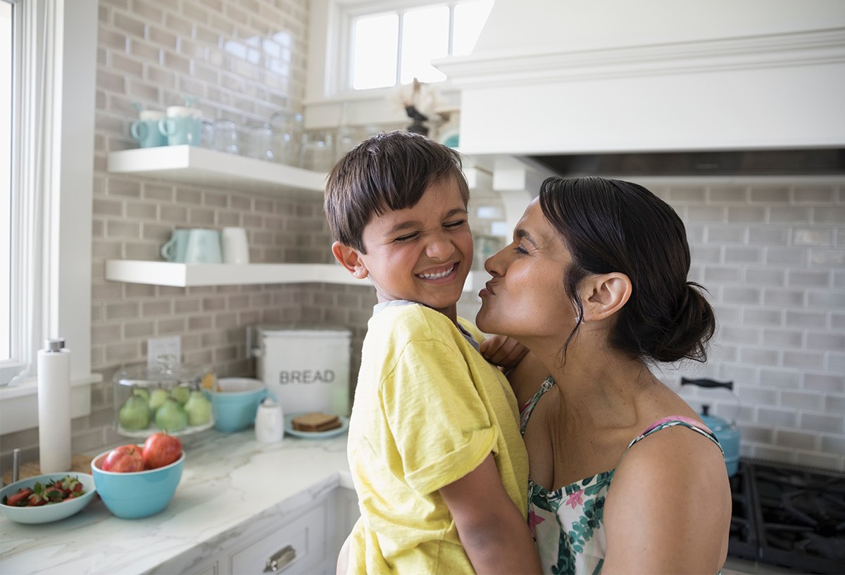 Mom kissing son on cheek